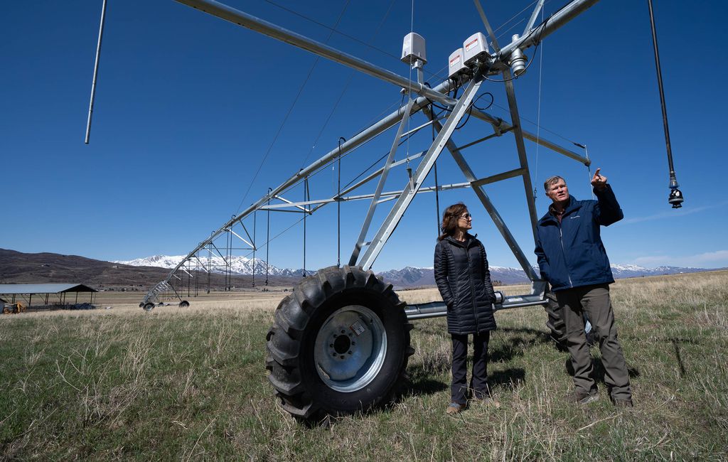 (Francisco Kjolseth | The Salt Lake Tribune) Bill White, alongside his wife, Alane, talks about the central pivot watering system he purchased to help preserve the farmland surrounding the Trappist monastery in Huntsville on Tuesday, April 13, 2021. A deal has been reached to preserve most of the 1,800-acre agricultural operation that surrounds the monastery grounds in the rapidly subdividing Ogden Valley. White has agreed to donate much of the development rights to the land so that it remains as agricultural open space. White has invested heavily in the land's agricultural operations so that it would qualify for the $8.8 million in federal grants that are funding most of the deal.
